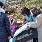 公園で中学校給食のあり方を問うシール投票に取り組む右から共産党の吉良よし子参院議員と田中美穂市議候補＝1月11日、東京都町田市